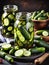 jars with pickled cucumbers on wooden table