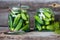 Jars of pickled marinated cucumbers on rustic table