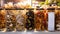 Jars of red and black chanterelles, champignons, and fairy-ring mushrooms on the grocery store counter.