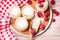 Jars with yogurt, raspberries, wooden scoop, spoon and oat flakes