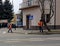 Jaslo/Poland-march 27,2018: The janitor in his working clothes sweeps the sidewalk. Cleaning of the territory in the city. The wor