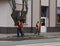 Jaslo/Poland-march 27,2018: The janitor in his working clothes sweeps the sidewalk. Cleaning of the territory in the city. The wor
