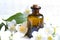 Jasmine aromatherapy oil on white planks with flowers