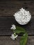 Jasmine floating in clear glass on wooden background