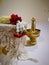 Jasmine flowers placed on a tray covered with white cloth and a tall brass holder