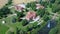 Jaunmoku Brick Medieval Castle Near Tukums, Latvia  at Pond With Fontain in Clear Sunny Summer Day From Above Top View.