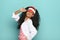 Jaunty happy young black woman wearing a red vintage visor