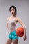 jaunty young woman posing with a basketball