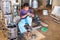 JAVA, INDONESIA - DECEMBER 21, 2016: Worker making kitchen utensils in Indonesia