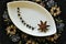 Java pepper and star anise on a decorative plate