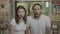 Jaw dropping reaction teenage couple watching something scary and unbelievable looking thrilled and astonished with open mouth -