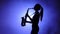 Jazz performed by musician girl playing saxophone. Silhouette, slow motion