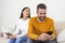 Jealous suspicious mad wife arguing with obsessed husband holding phone texting cheating on cellphone, distrustful girlfriend