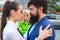 Jealous woman look at couple in love on street. Really jealous of him. Romantic couple of man and woman dating. Bearded