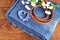 Jeans, bracelet, belt on wooden background. Top view