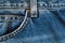 Jeans denim, pants front pockets, seams with orange threads, close-up macro view