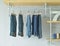 Jeans hanging in industrial style walk in closet at home