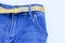 Jeans and measuring subject for weight loss on blue background