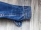 Jeans sleeve jacket, blue color on wooden background