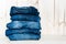 Jeans stacked on a wooden background