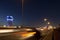 Jeddah water tower at night, with car lights motion on the street.