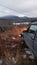 A jeep cherokee looking over a frozen lake from on top a mountain