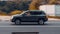 Jeep Compass car driving on the country road at sunset. Side view of gray SUV in motion on the background of autumn nature