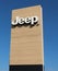 Jeep logo on wood background outside the car dealership of the area. It is the symbol of the american automaker, today a division