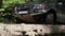 Jeep rides through the mud in the woods