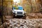 Jeep Rubicon going downhill a muddy trail.