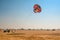 Jeep towing a parachute for adventure para gliding in the empty barren thar desert in rajasthan near jaisalmer and sum