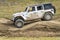 Jeep Wrangler, Rubicon model, on a muddy and bumpy training drive off-road course