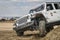 Jeep Wrangler, Rubicon model, on a muddy training drive off-road course