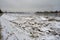 Jekabpils after the flood. River Daugava with ice piles on the banks. A dark, dreary January day