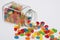 Jelly Beans candy spilled from glass jar on white backg
