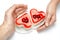 Jelly heart-shaped cakes in hands of lovers