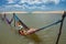 Jericoacoara Lake - Woman lying in a hammock in the water. CearÃ¡ Brazil