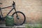 Jerrycan against red brick wall. Empty Gas canister next to the bicycle. Cycling while fuel shortage