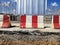 Jersey barrier, or Jersey wall, Cement road block barrier on construction area, red and white concrete barrier.