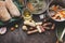 Jerusalem artichoke cooking preparation on rustic kitchen table with pot, diced vegetables, oil and ingredients