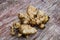 Jerusalem artichoke or ground pear Helianthus tuberosus, fresh root vegetables, tubers lie on a wooden table.Healthy diet food f