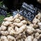 Jerusalem artichokes and fine bean for sale at a farmers market