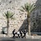 Jerusalem, Israel, 06.07.2007 four Jewish young men walk down the street along the stone wall