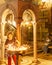 JERUSALEM, ISRAEL - April 2, 2018: woman sets candles in the Church of the Holy Sepulchre.