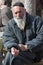 JERUSALEM, ISRAEL - MARCH 15, 2006: Purim carnival. Portrait of a tramp begging. An elderly man in a black jacket, kippa and beard