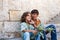 Jerusalem, Israel - September 11, 2011: Two jewish boys sitting on the steps near the stone wall and posing for photo in Jerusalem