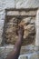 JERUSALEM, ISRAEL. Touching the Holy stone on The Via Dolorosa