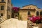 Jerusalem Israeli ancient city street landmark urban view paves road and stone small building and flowers vases landscaping