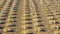 Jesolo, Italy. Beach umbrellas and sun beds at Italian sandy beach. Raws of Yellow and white umbrellas. Aerial view at sunrise