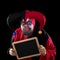 Jester holding a slate with copyspace, black background